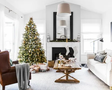 Christmas tree and decorations in a cozy living room with a fireplace, stockings, and a coffee table with gifts.