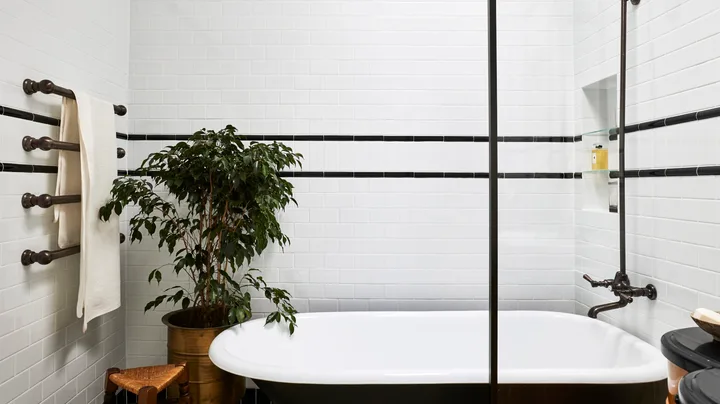 A claw foot bath in a 1920s inspired art deco bathroom.