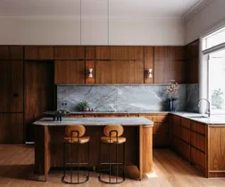 American walnut kitchen with a quartzite stone splashback and benchtop.