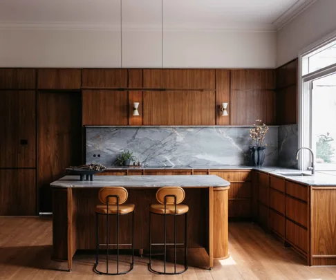 American walnut kitchen with a quartzite stone splashback and benchtop.