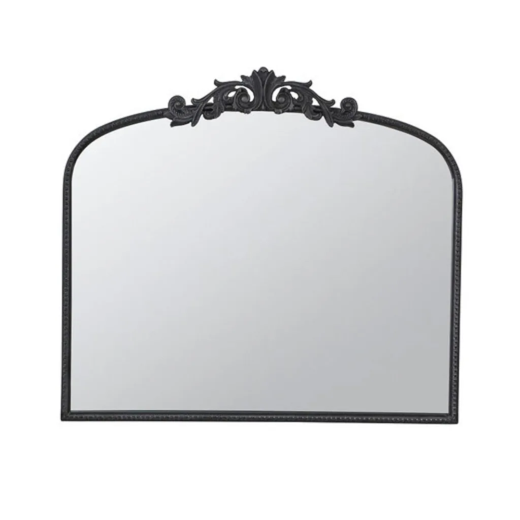 A black gilded arched mirror. 
