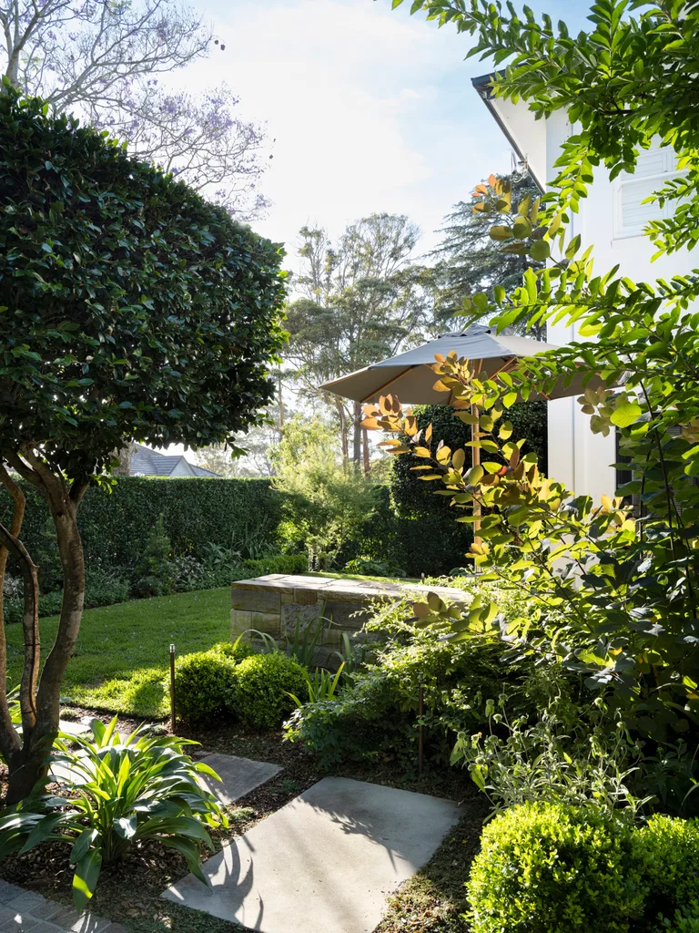 Groundcover of young Pratia pedunculata joins sandstone steppers that lead visitors through the garden to the entry portico and front door