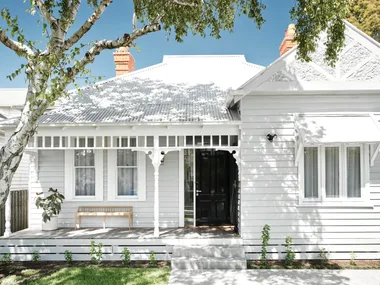 Renovated white Victorian cottage facade.