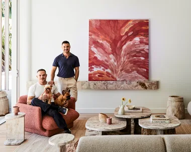 Darren Palmer with Olivier Duvillard and their dogs in the living room.