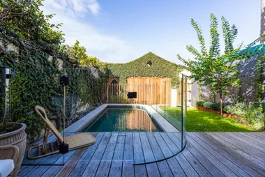 A garden makeover with a pool, deck and lawn.