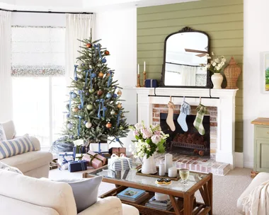 A classic living area with green accents and a Christmas tree.
