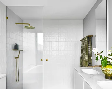 ensuite with white wall tiles and grey marble floor