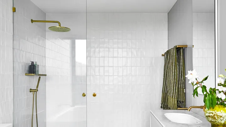 ensuite with white wall tiles and grey marble floor