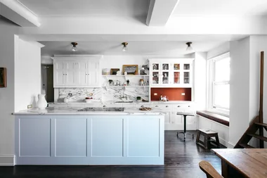 contemporary kitchen with marble slab splashback and pale blue kitchen cabinetry