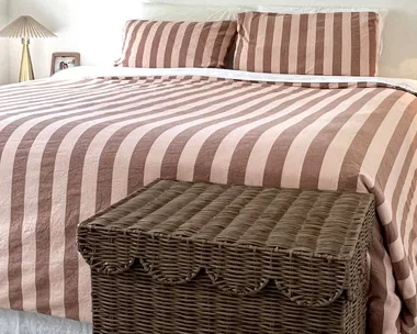 Most aesthetic laundry basket against bed