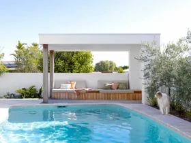 Pool and cabana with a dog