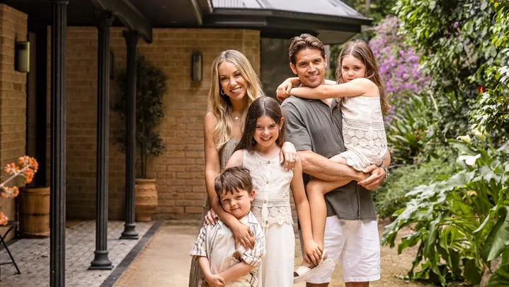 Rachel and Ryan Carr with their three children at their South Coast holiday house.