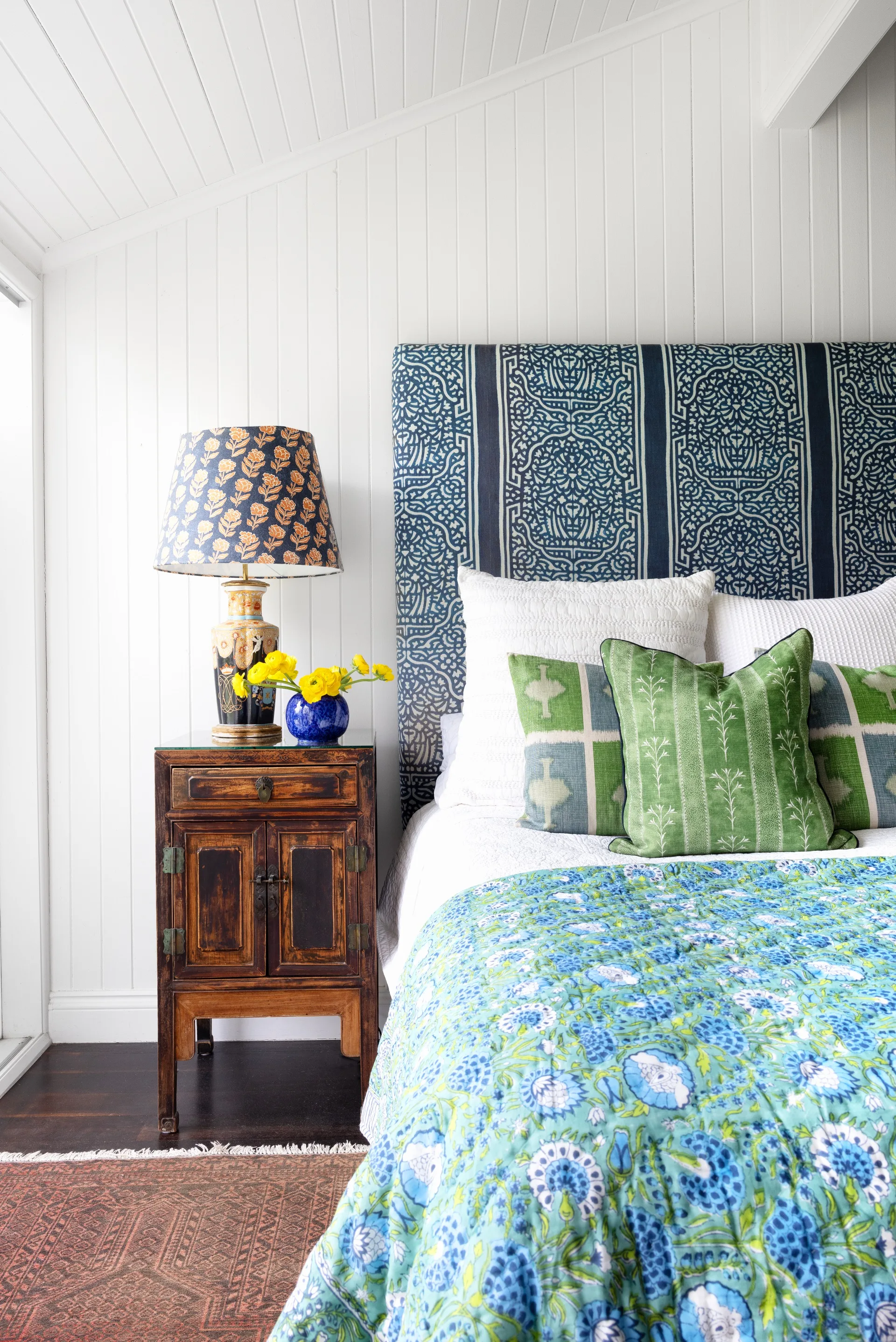 The main bedroom decorated with a bright assortment of patterned textiles.