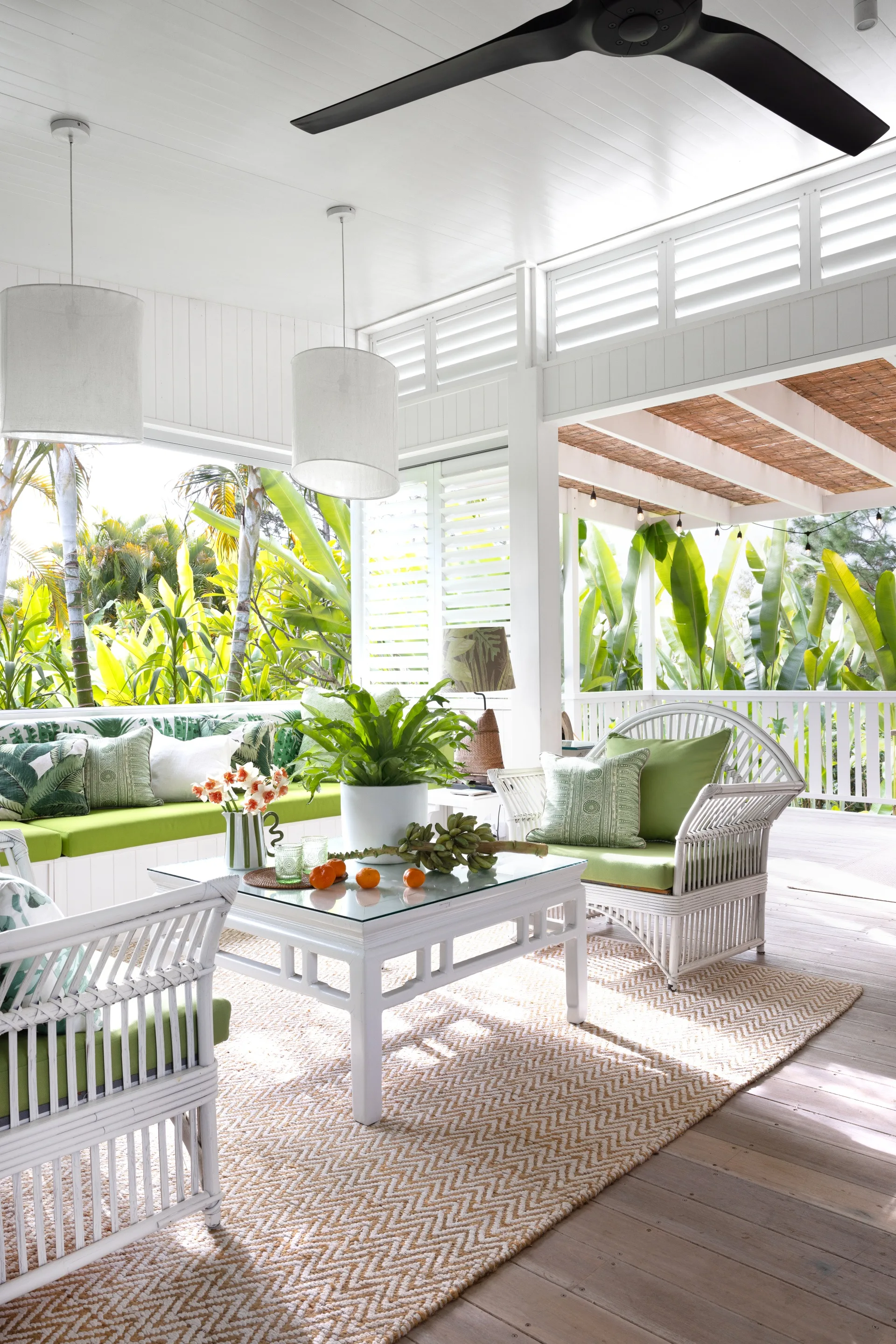 The outdoor lounge area surrounded by tropical greenery.